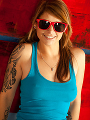 Teen babe in red sunglasses shows her tits